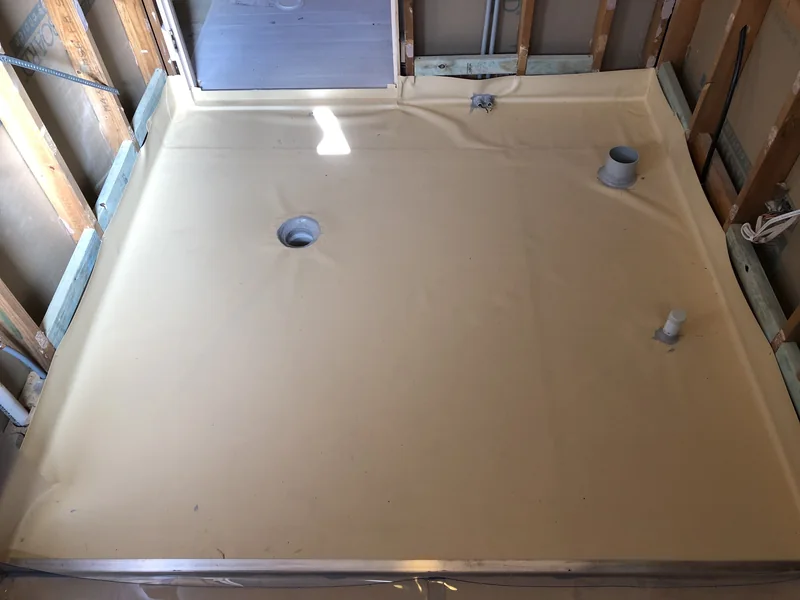 Wet-area floor membrane and service penetrations during the Avoca Beach renovation