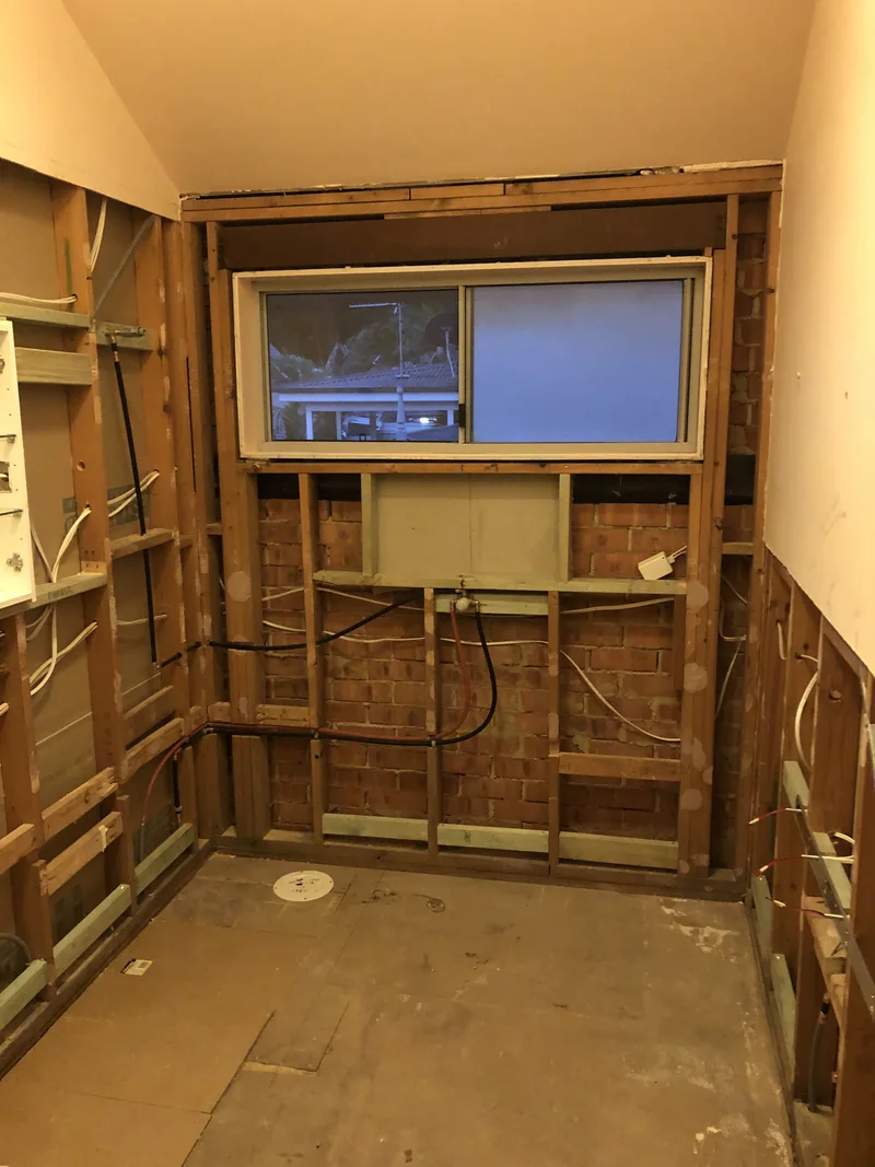 Bathroom strip-out and exposed services during the Avoca Beach renovation