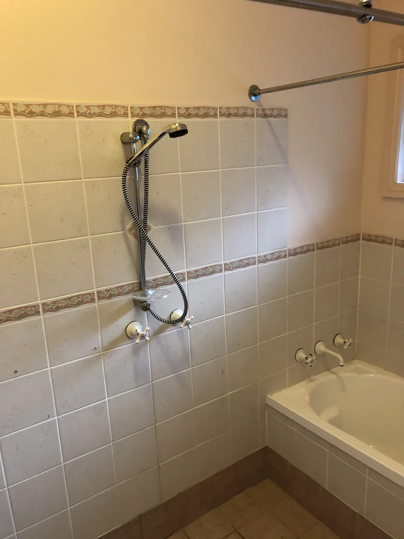 Shower over bath before the Avoca Beach bathroom renovation