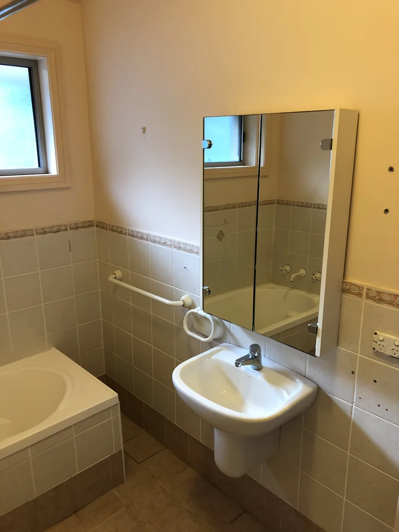 Pedestal basin and mirrored cabinet before the Avoca Beach bathroom renovation