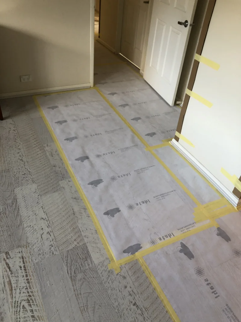 Cronulla bedroom before flooring and window works, with surfaces protected