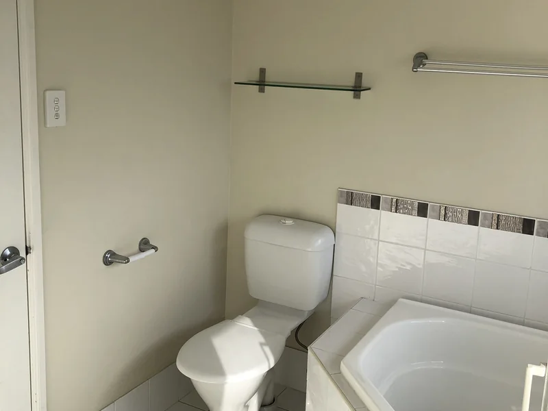 Main bathroom bath and toilet zone before renovation in Cronulla