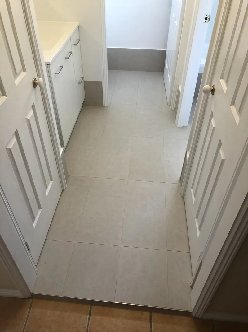 Coordinated wet-area floor transitions after renovation in Castle Hill