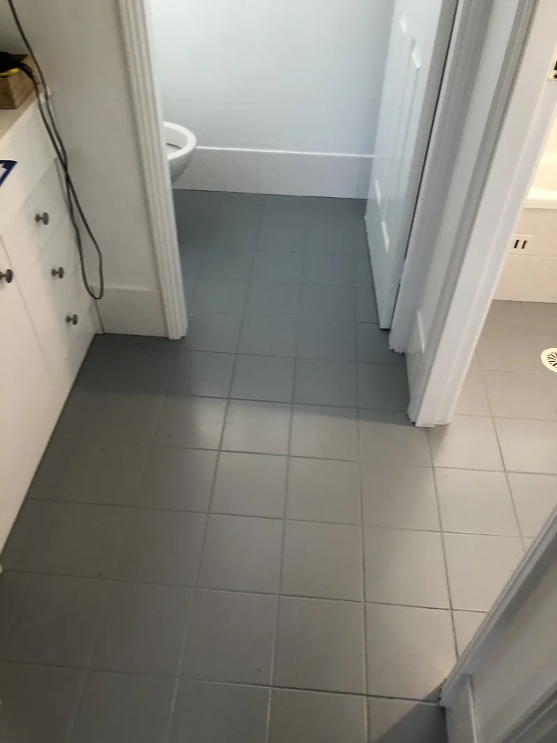Wet-area floor transitions before renovation in Castle Hill