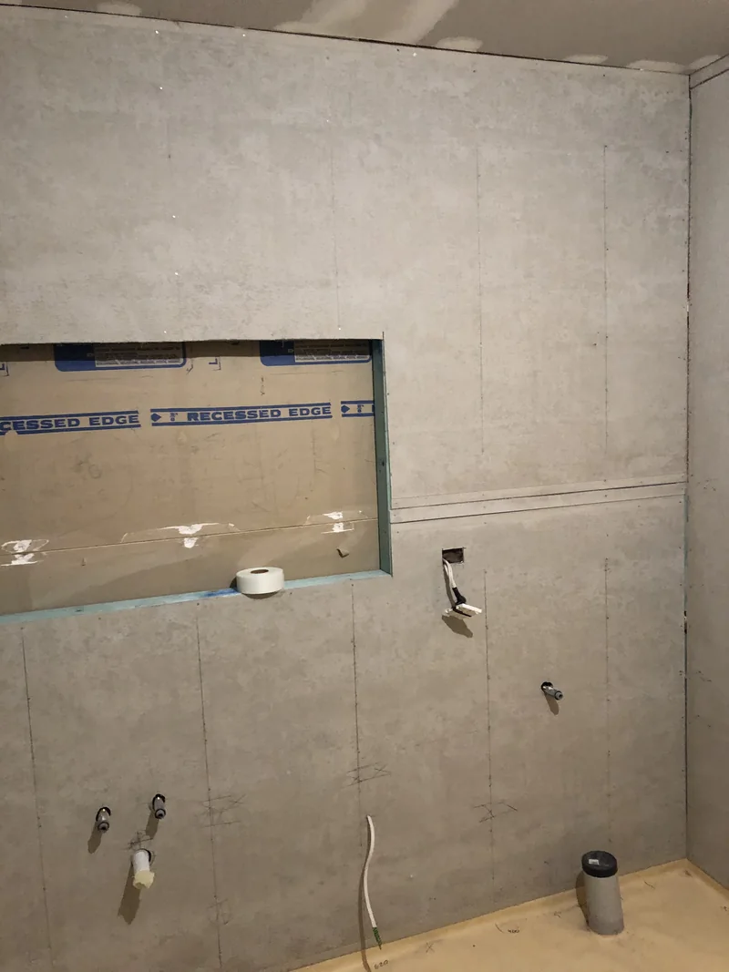 Wet-area wall linings and recessed cabinet set-out during the Lisarow renovation