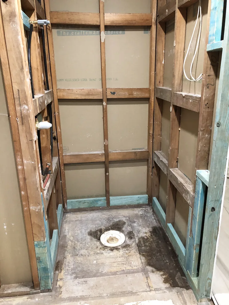 Stripped shower bay and exposed floor waste during the Mardi ensuite renovation