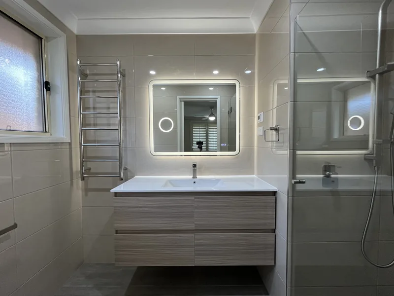 Floating vanity, illuminated mirror and heated towel rail after the Mardi ensuite renovation