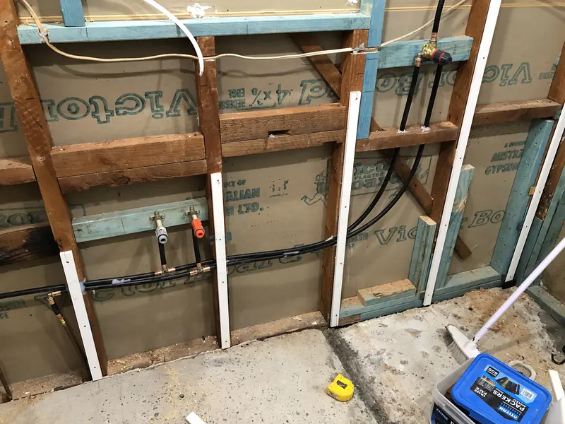 Wall framing and new plumbing during the North Gosford renovation